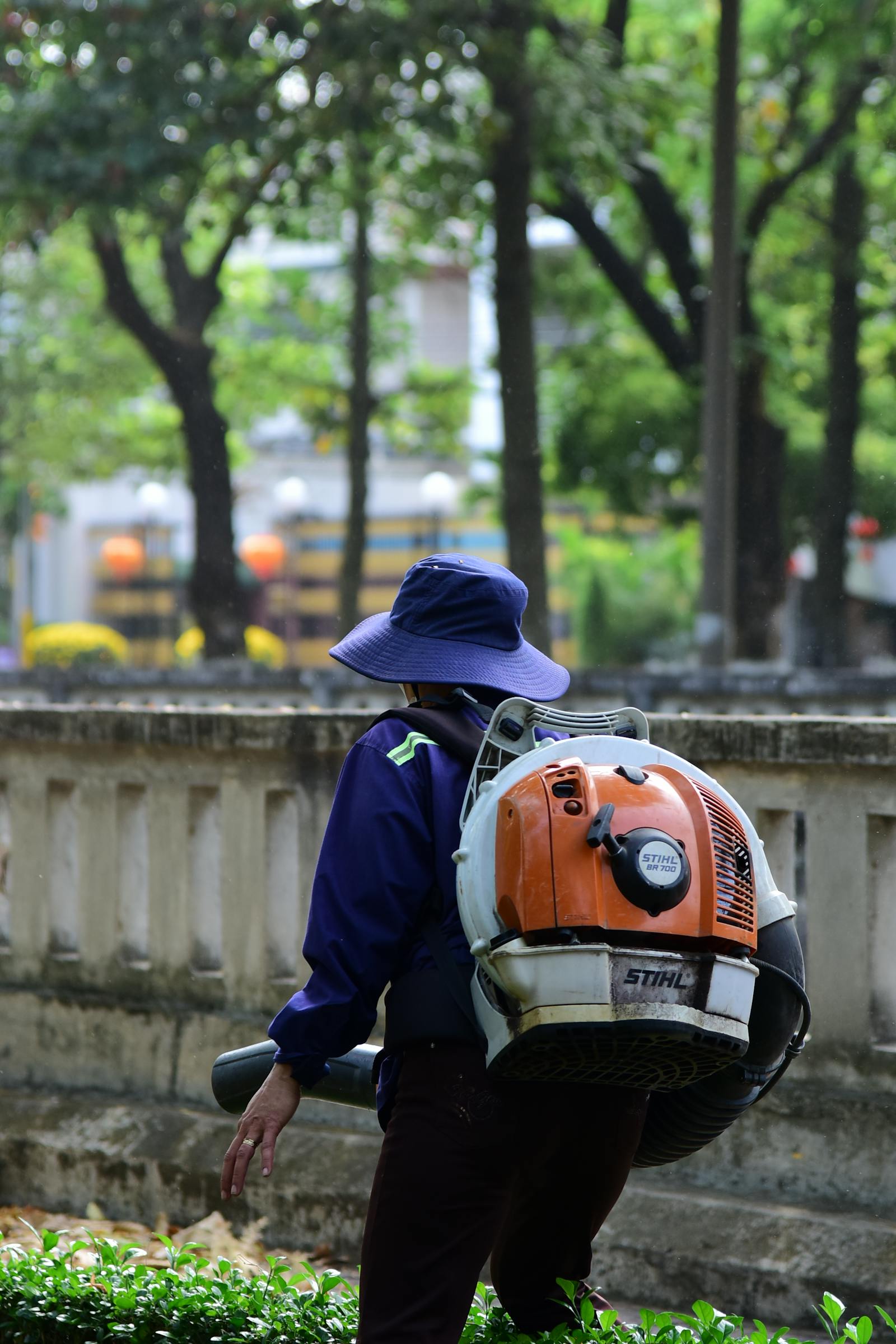 Backpack blower clearing fallen leaves into a tidy pile during a fall cleanup.